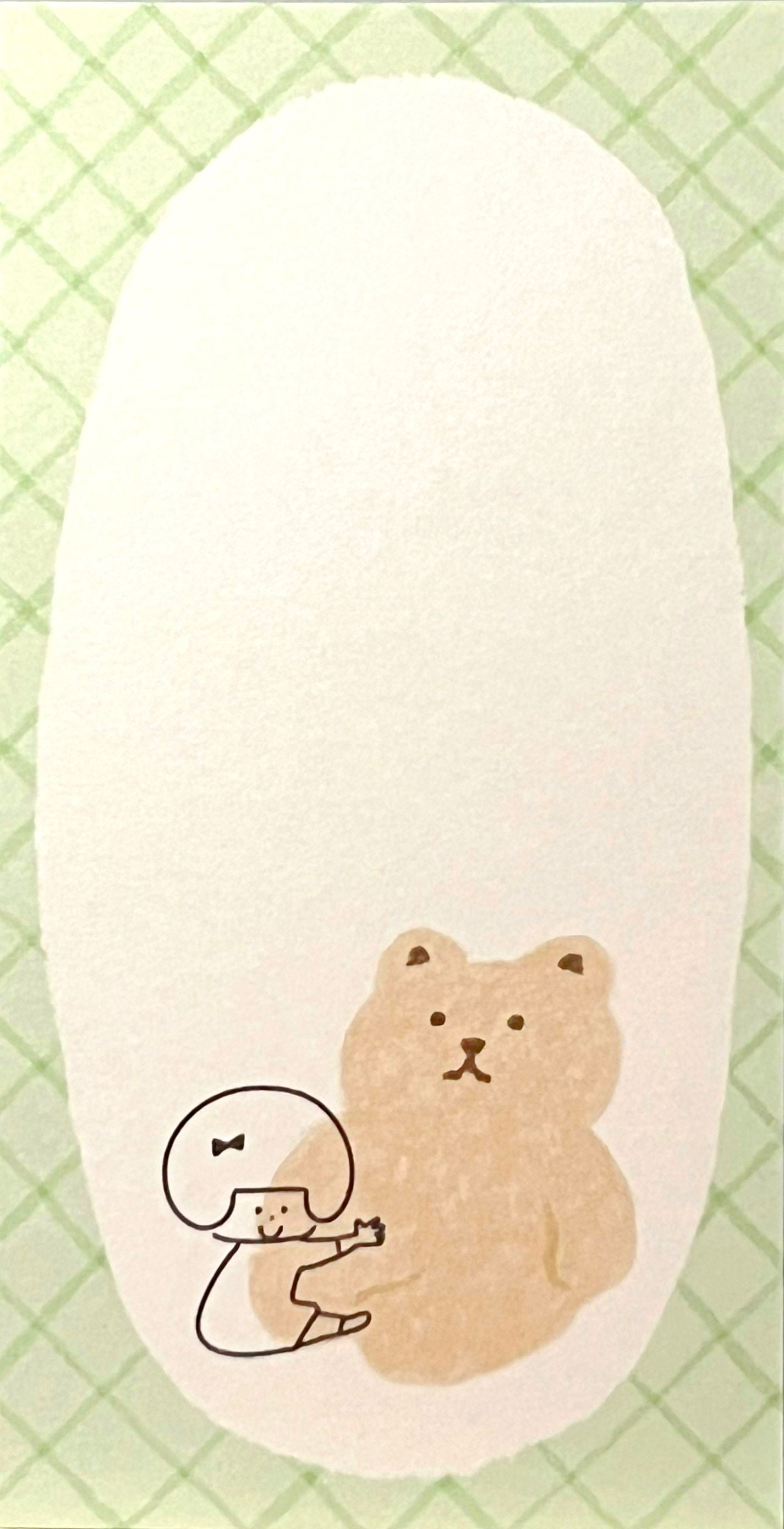 ゆるいタッチで描かれた女の子とくまのイラストが入った、ふんわり優しい雰囲気のスリムメモ帳。淡い色のデコレーションが特徴。/
A slim memo pad featuring soft pastel decorations and gentle hand-drawn illustrations of a girl and bears — soothing and whimsical stationery design.